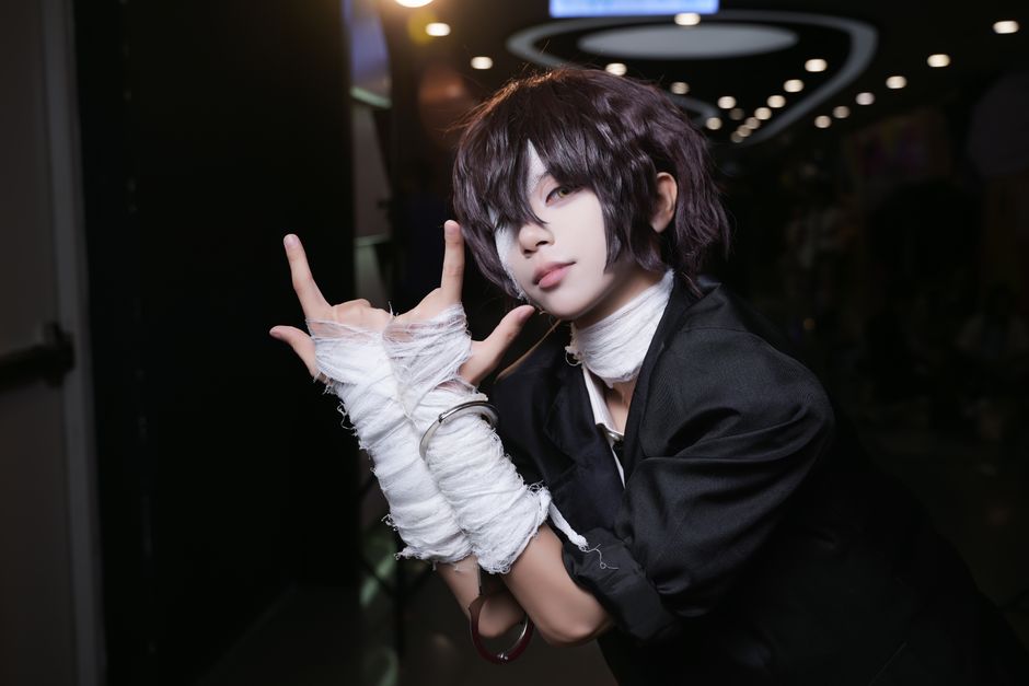 Engaging portrait of a cosplayer posing dramatically in costume indoors.