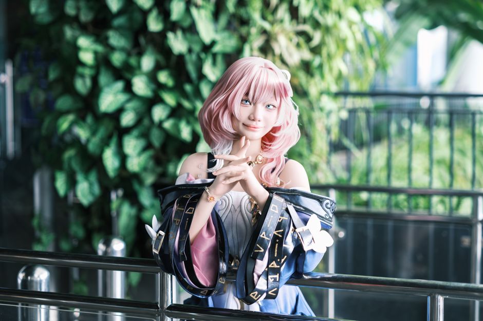Engaging portrait of a cosplayer posing dramatically in costume indoors.